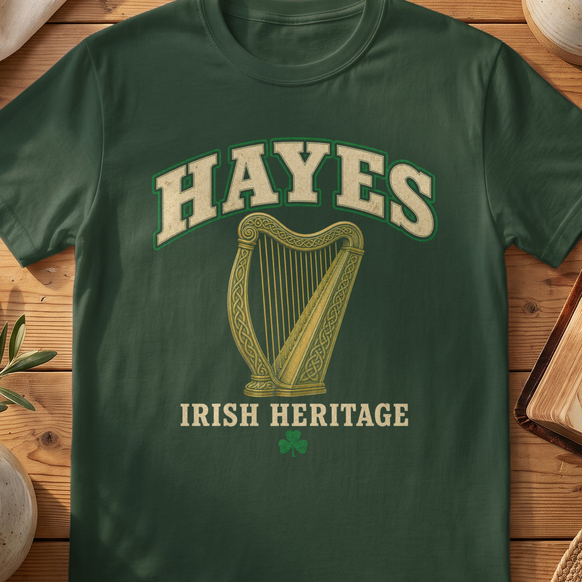 Hayes Irish harp T-shirt in Forest Green, with cream surname lettering, a gold-toned harp, green shamrock and “Irish Heritage” text.