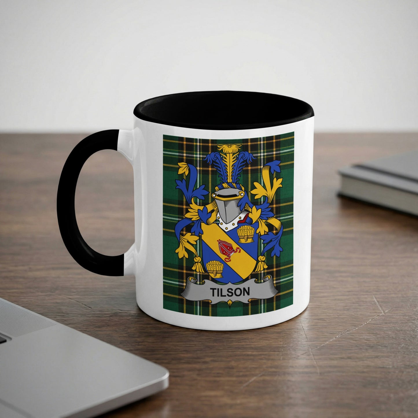 White mug with black rim featuring the Tilson family crest on the side.