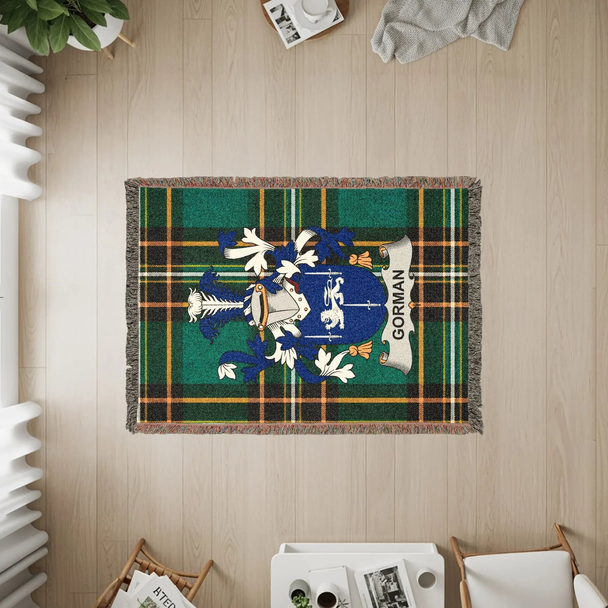 Gorman clan crest on a green tartan throw blanket, seen from above.