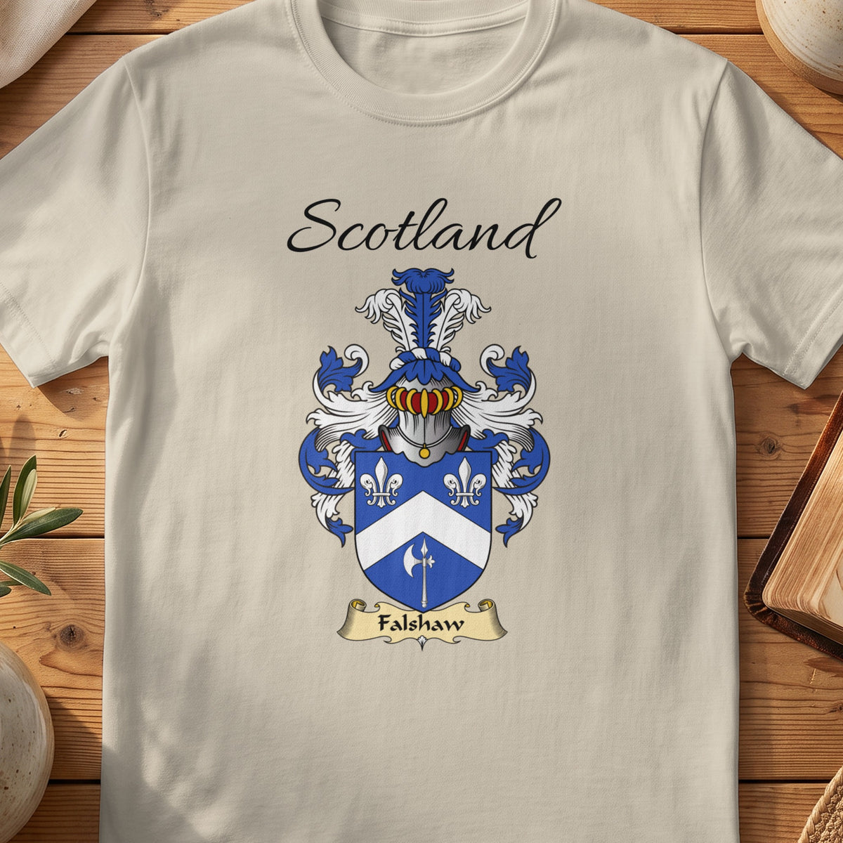 Sand Falshaw Scottish family shield T-shirt featuring a white chevron and floral motifs on blue