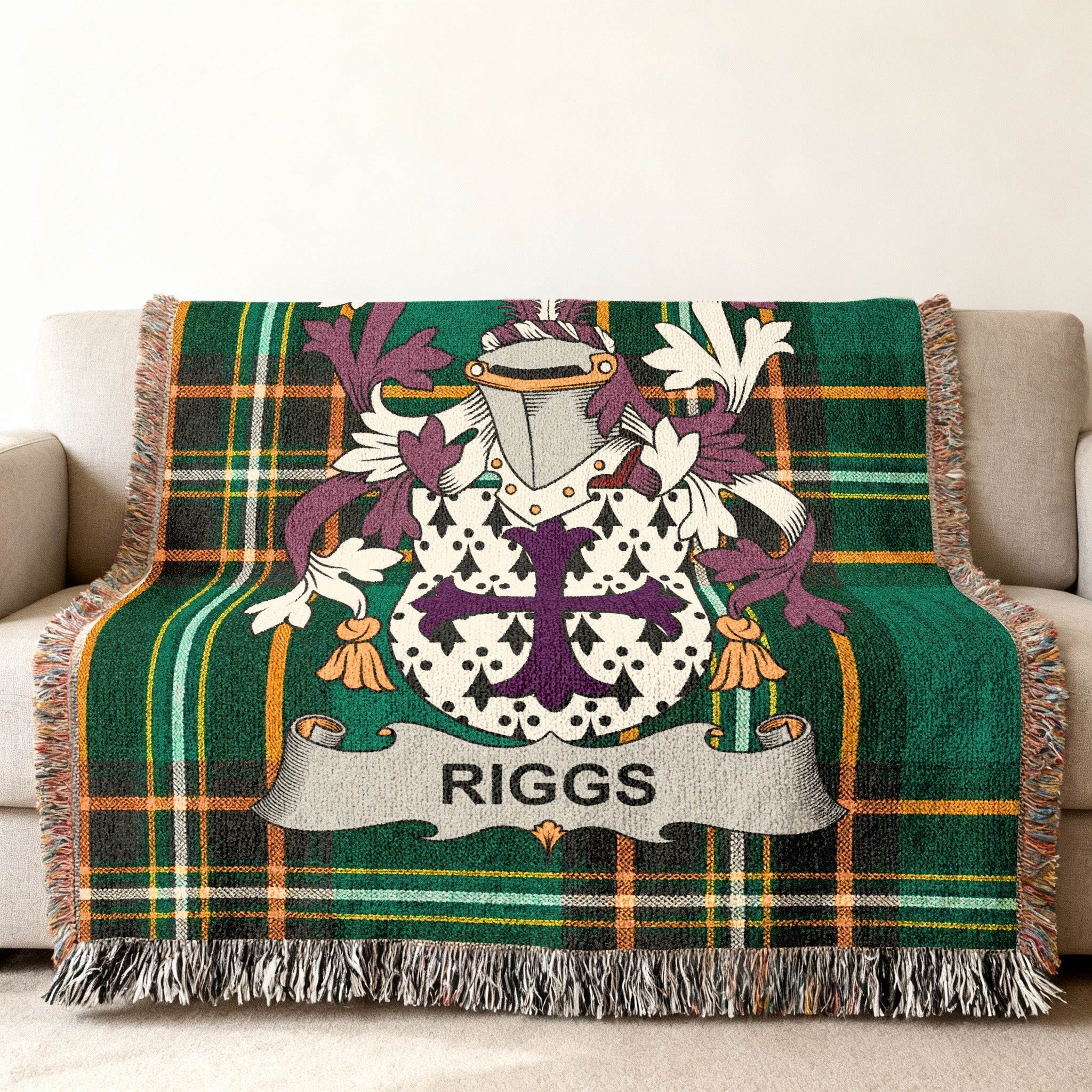 Green plaid throw blanket featuring a family crest with the name "RIGGS".