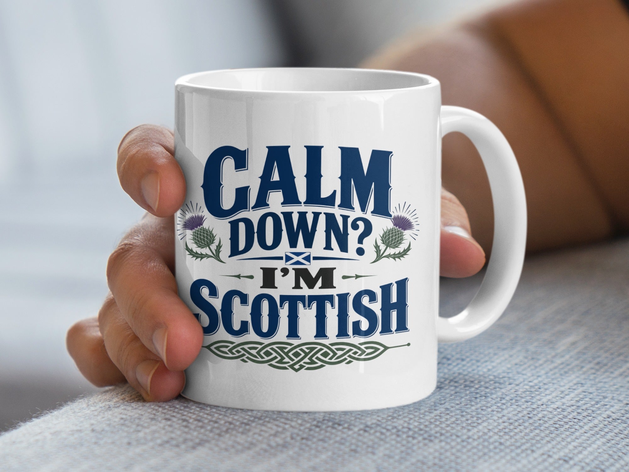 White mug with "Calm Down? I'm Scottish" and thistle designs.