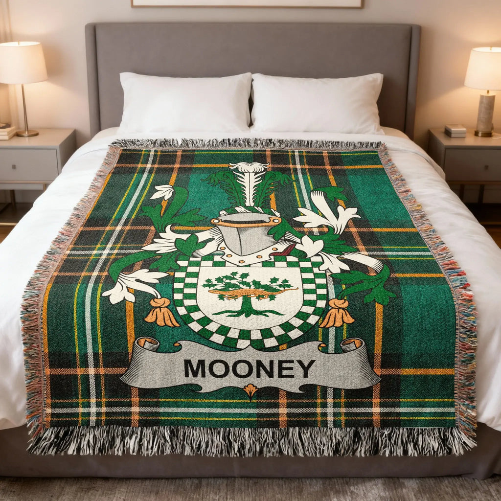 Tartan blanket with Mooney coat of arms on a bed.