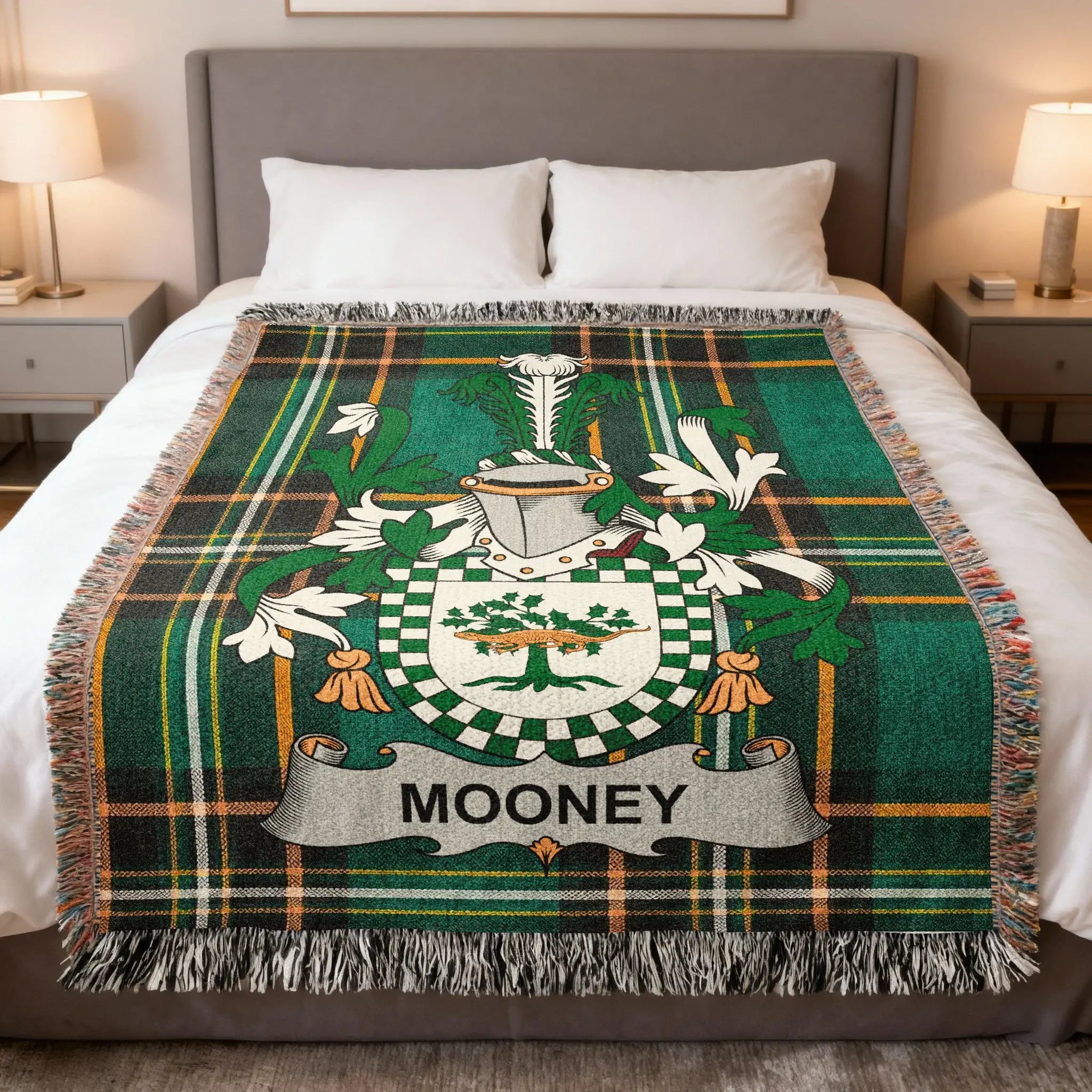 Tartan blanket with Mooney coat of arms on a bed.