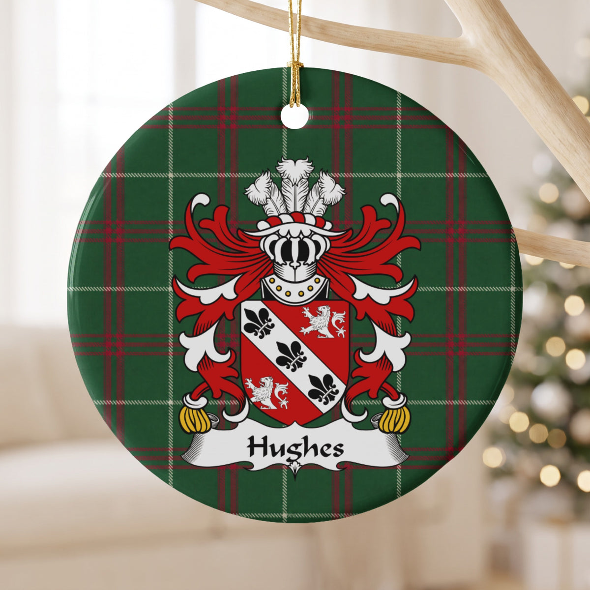 Hughes Style 4 ornament hanging from a pale wooden branch; a white diagonal band with black fleurs-de-lis between two white lions on a red shield on Welsh national tartan.