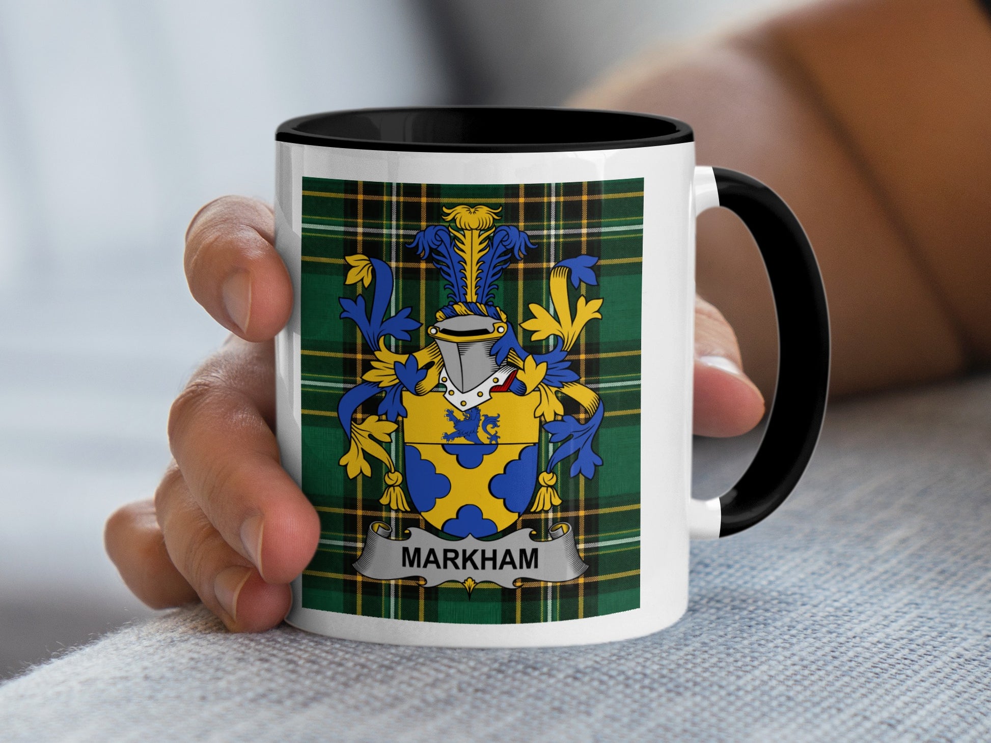 White mug with black handle featuring a family crest and "MARKHAM" text.
