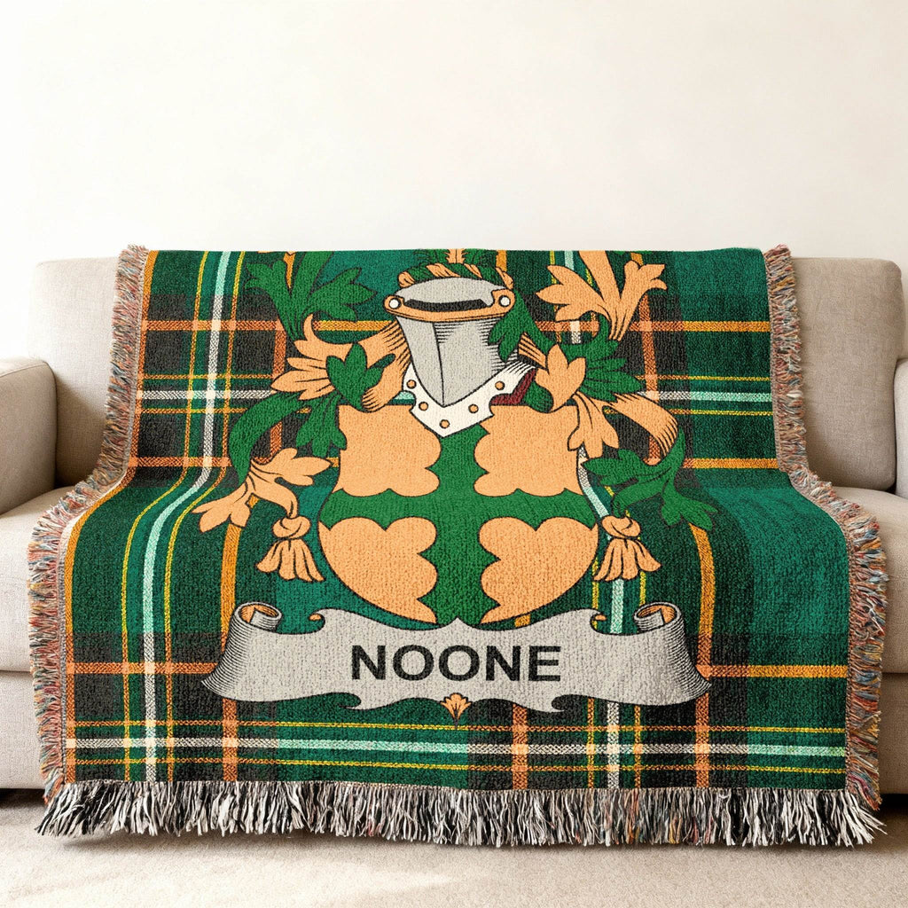 Woven blanket with green plaid and the Noone family crest.