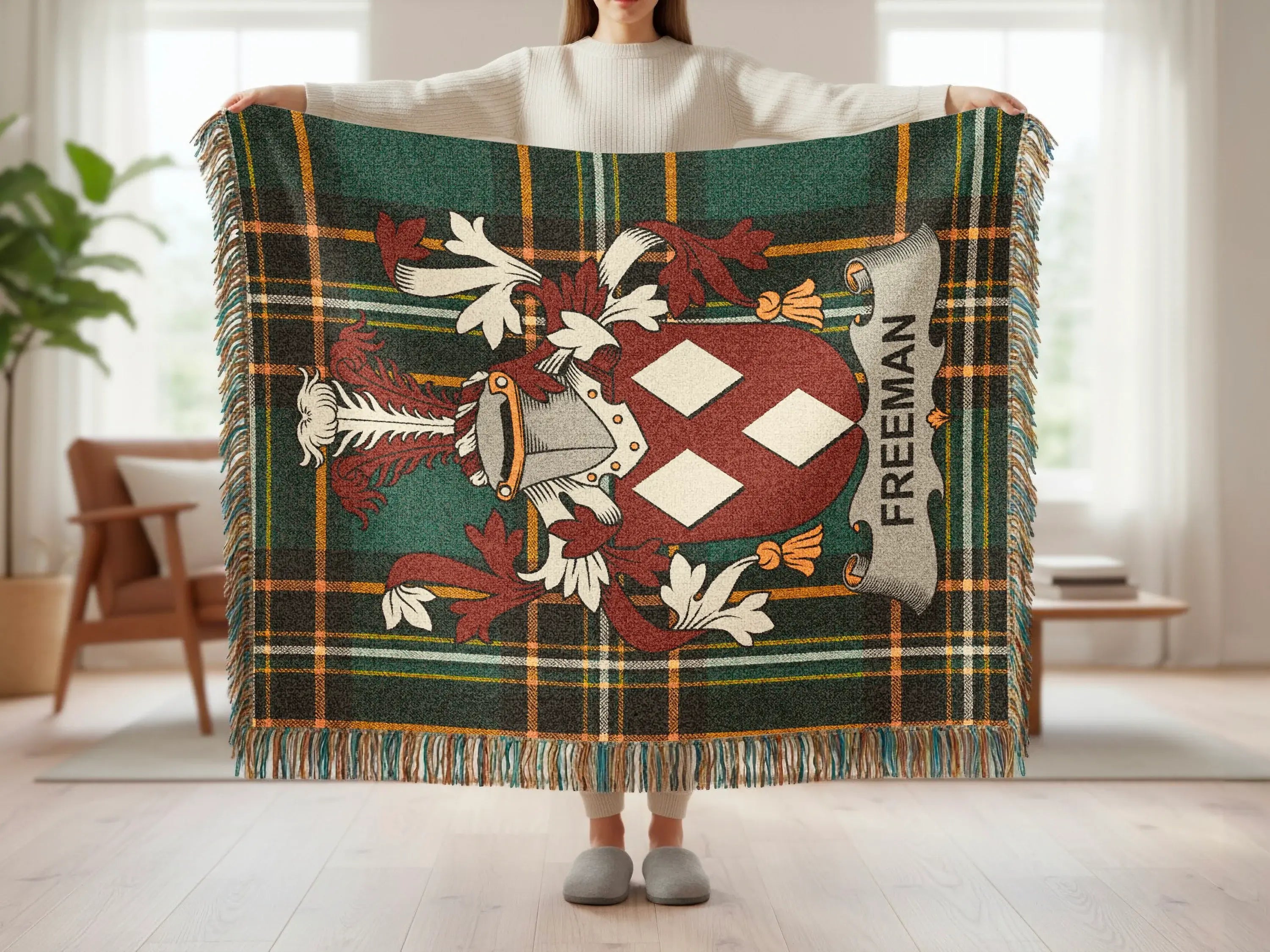 Tartan throw with Freeman family crest and fringed edges.