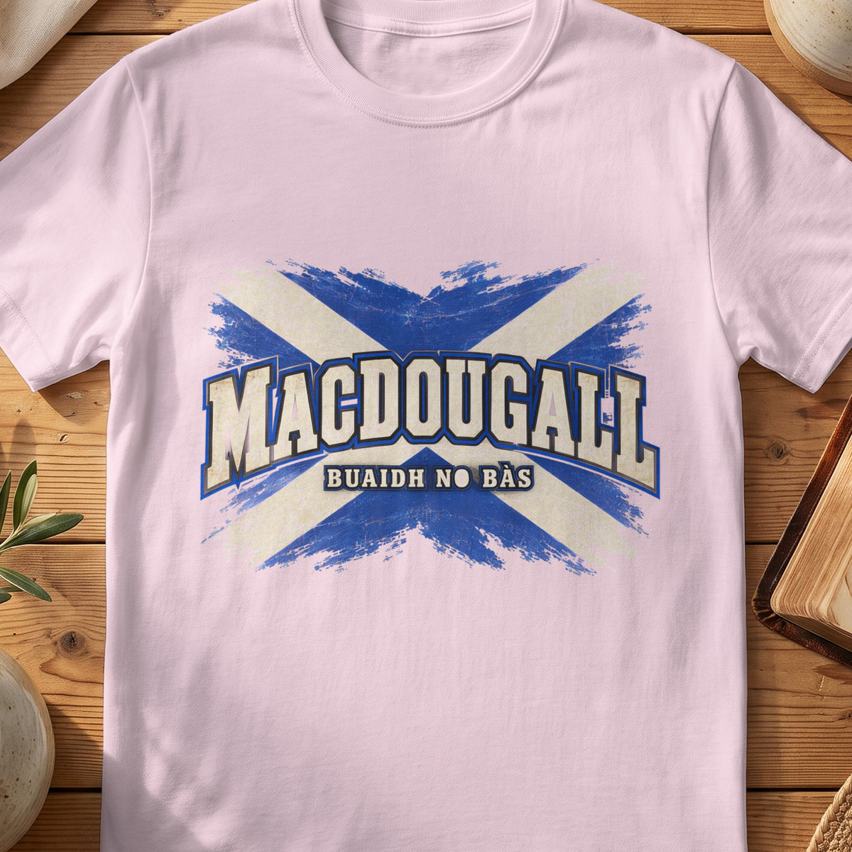 MacDougall Scottish Saltire T-shirt in Light Pink, with distressed blue and cream flag and “Buaidh No Bàs” lettering.