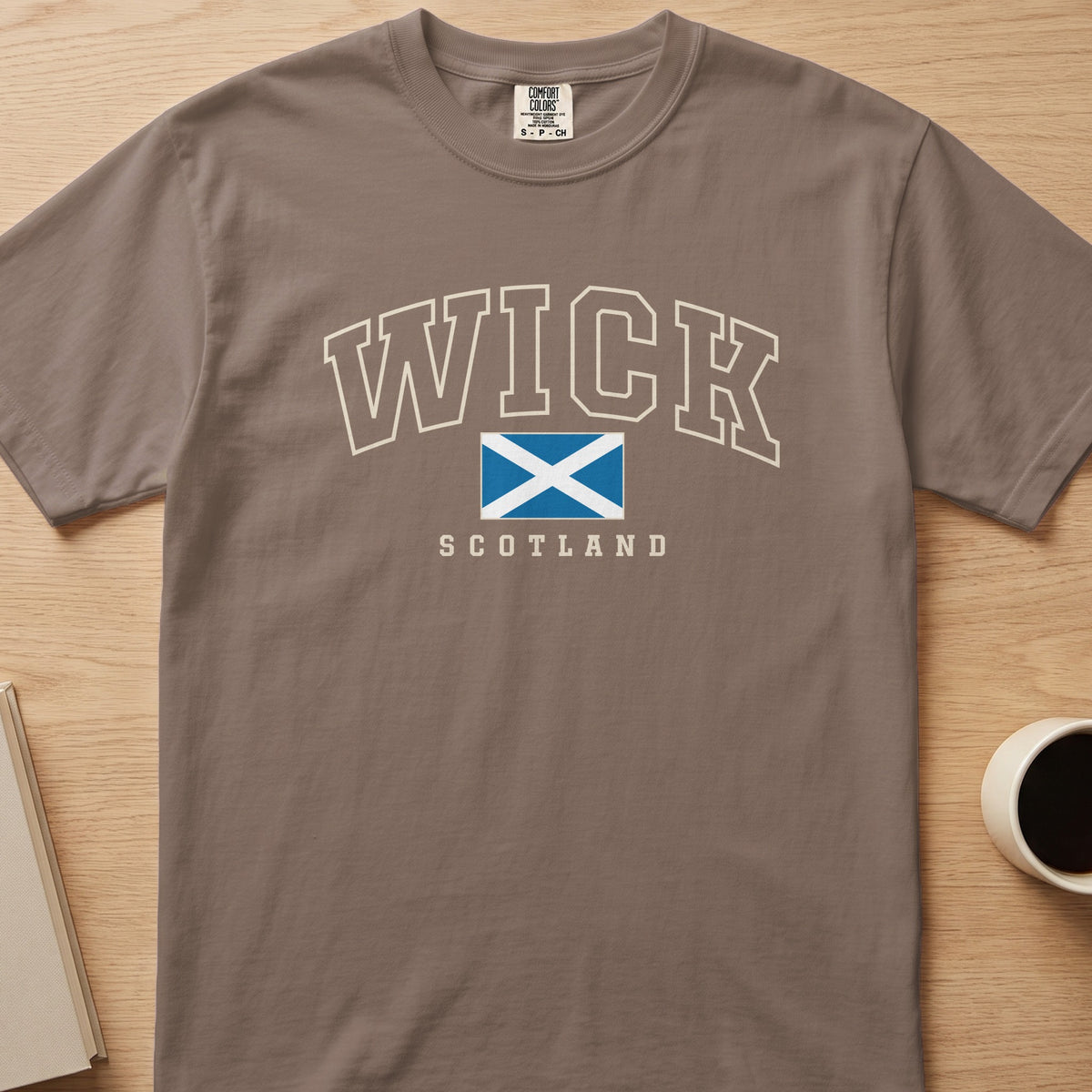Espresso Wick Scotland Comfort Colors T-shirt laid flat, showing the Saltire front design