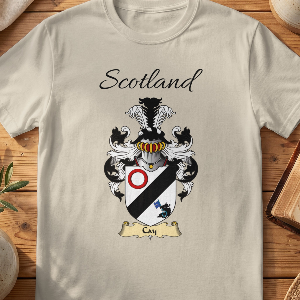 Sand Cay Scottish family shield T-shirt featuring a black diagonal band with a red ring