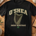 O'Shea Irish harp T-shirt in Black, with cream surname lettering, a gold-toned harp, green shamrock and “Irish Heritage” text.