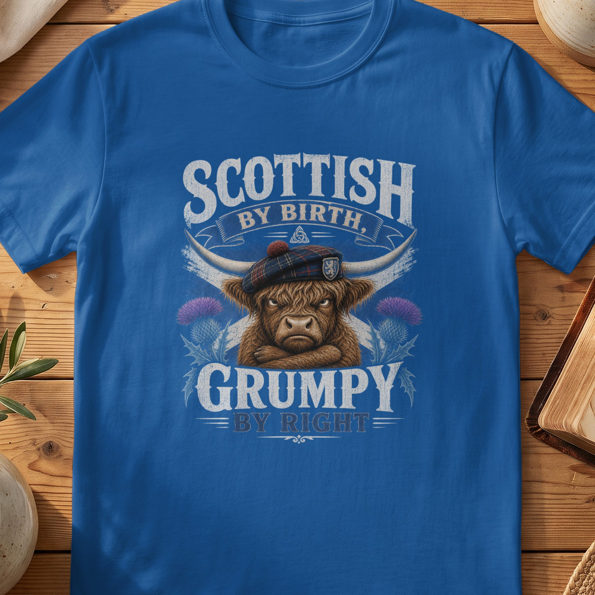 Blue t-shirt with "Scottish by Birth, Grumpy by Right" text and a grumpy Highland cow.