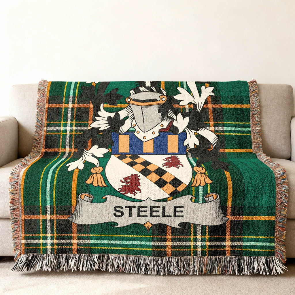 Green plaid throw blanket with the Steele family crest displayed centrally.