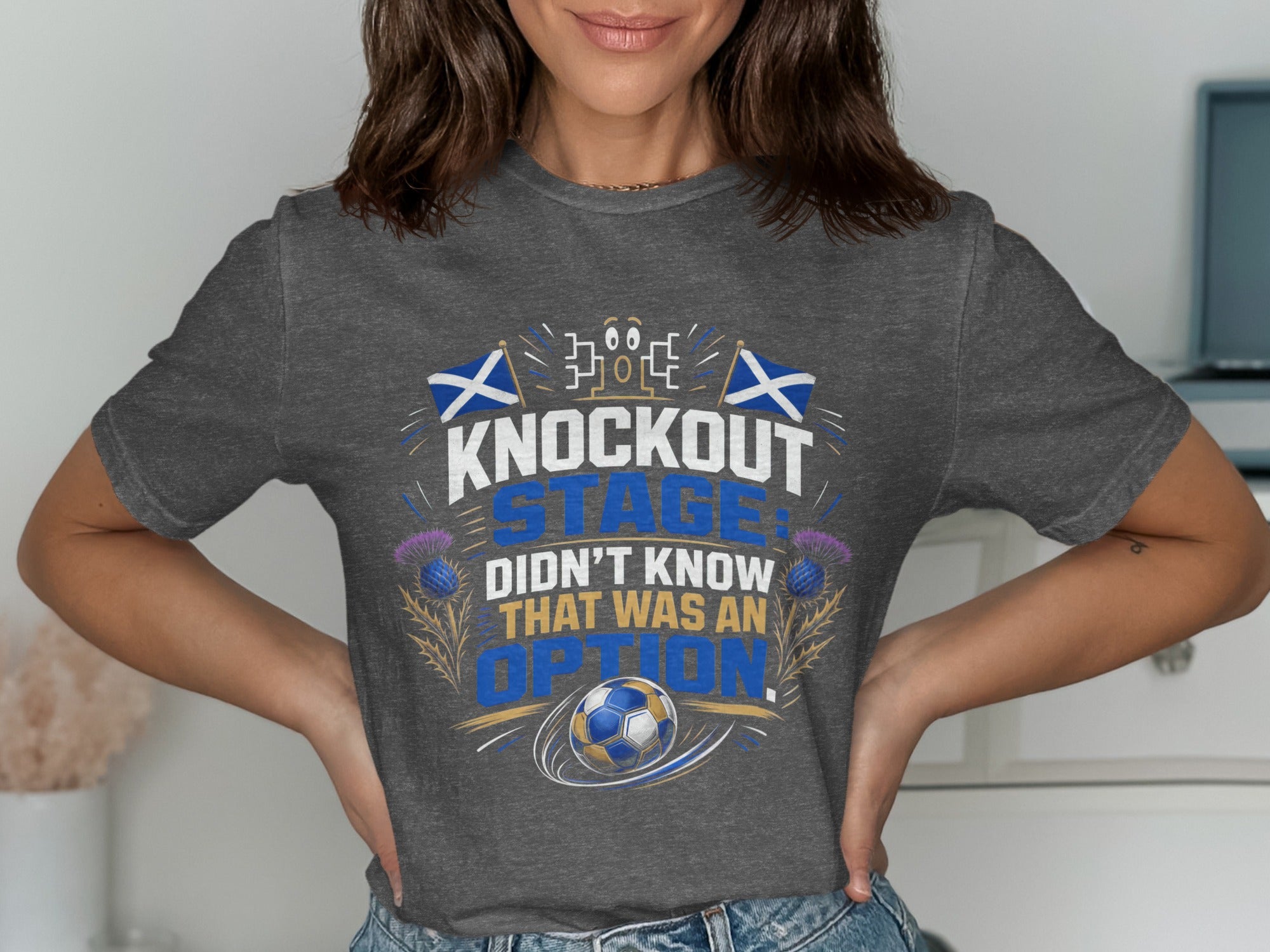 Grey t-shirt with "Knockout Stage Didn't Know That Was An Option" text and soccer ball.
