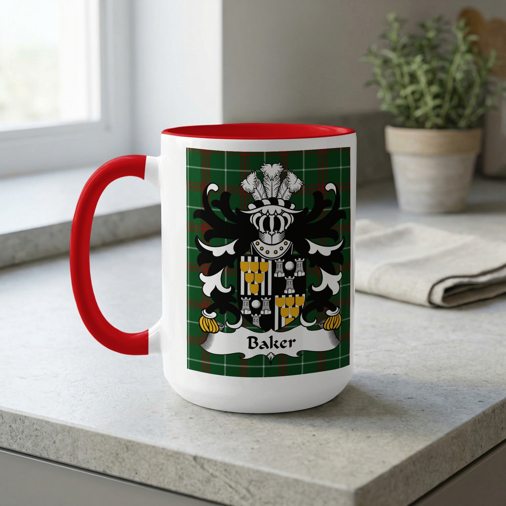 White mug with red handle featuring a tartan pattern and the Baker family crest.