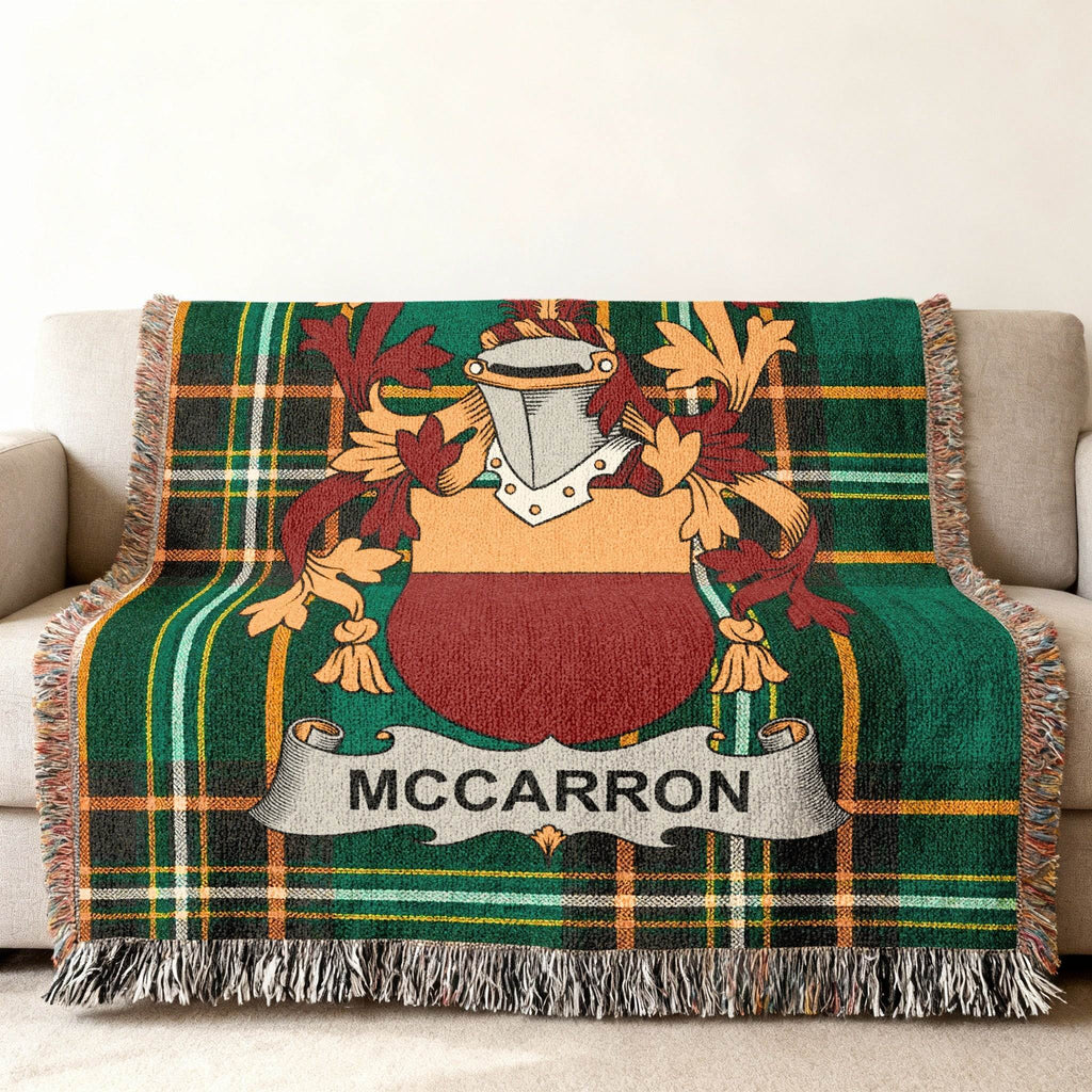 McCarron family crest on a green tartan plaid woven throw blanket.