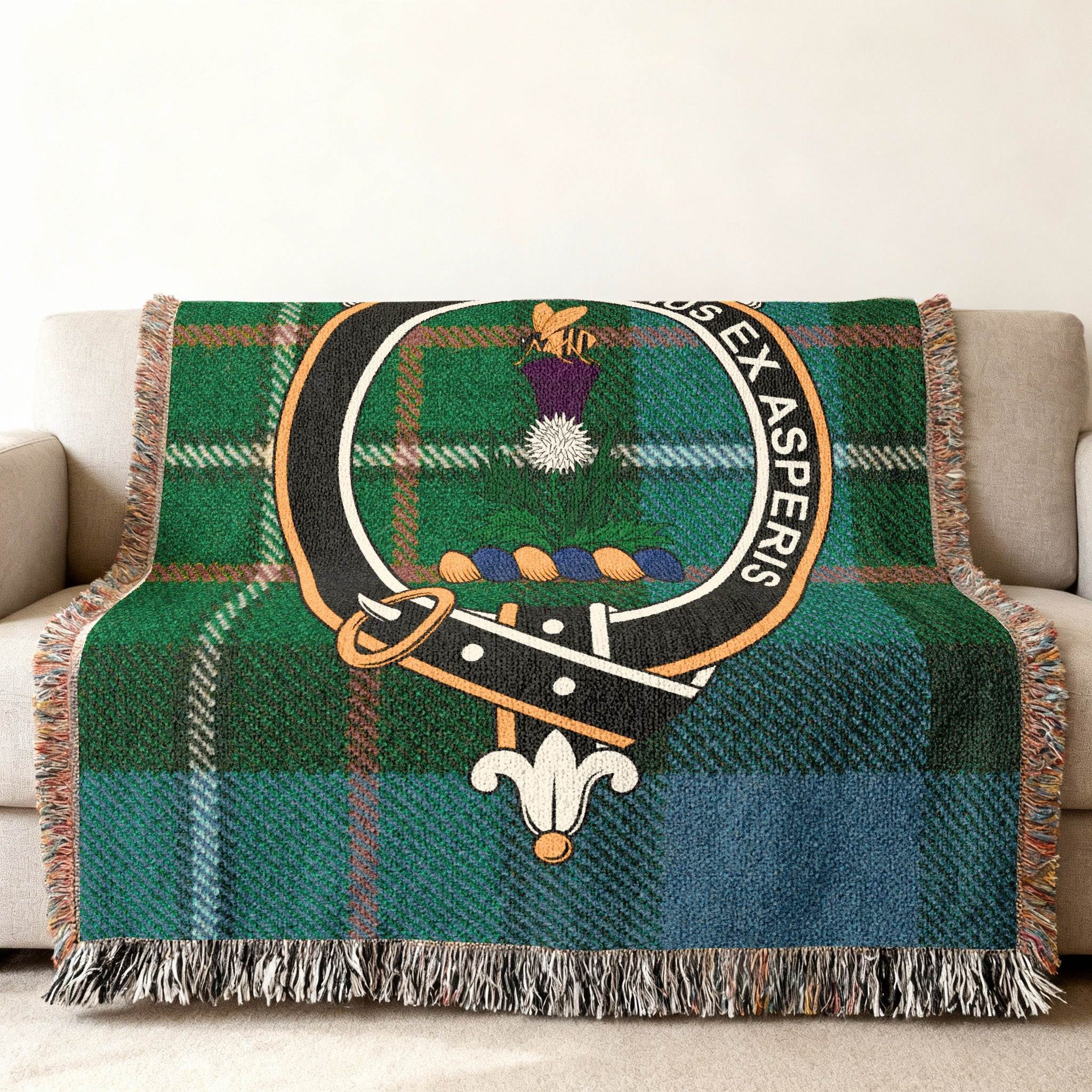 Ferguson tartan woven blanket draped — clan crest on tartan background, fringe edges