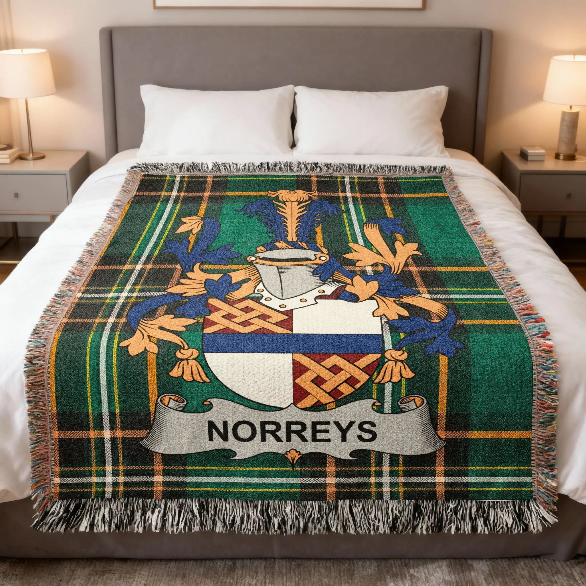 Green tartan throw blanket with Norreys family crest on a bed.