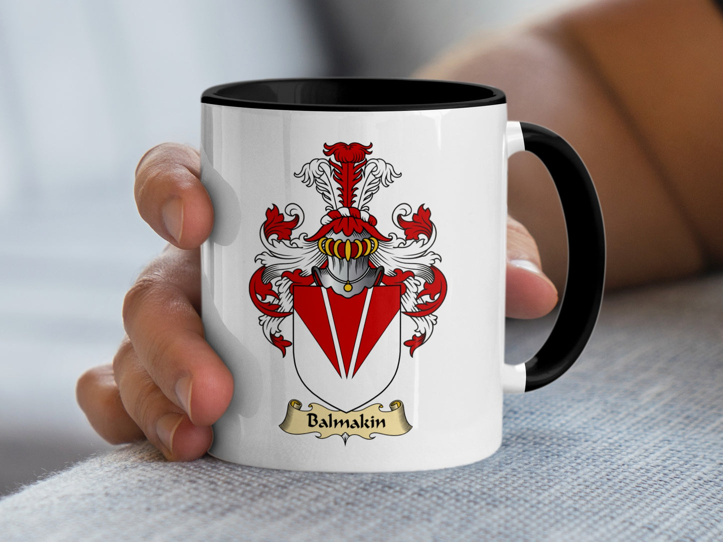 White mug with black rim featuring a red and gold Balmakin family crest.