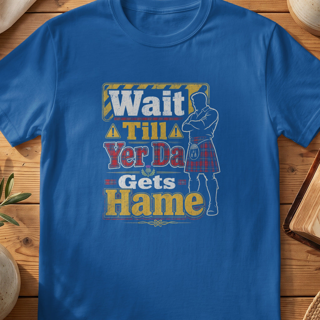Blue t-shirt with a graphic of a man in a kilt and text: Wait Tilla Yer Da Gets Hame.