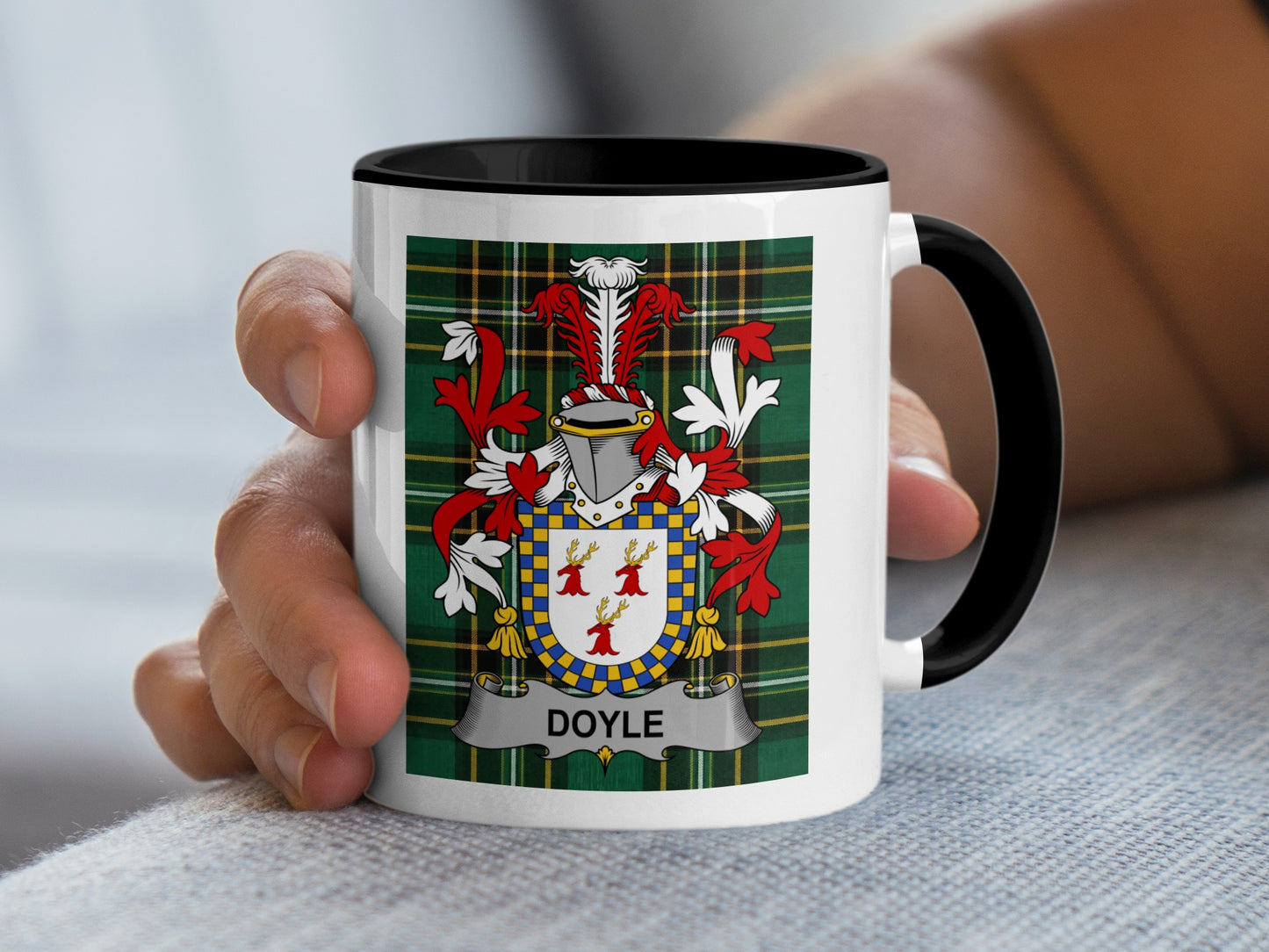 White mug with black rim featuring the Doyle family crest on tartan background.