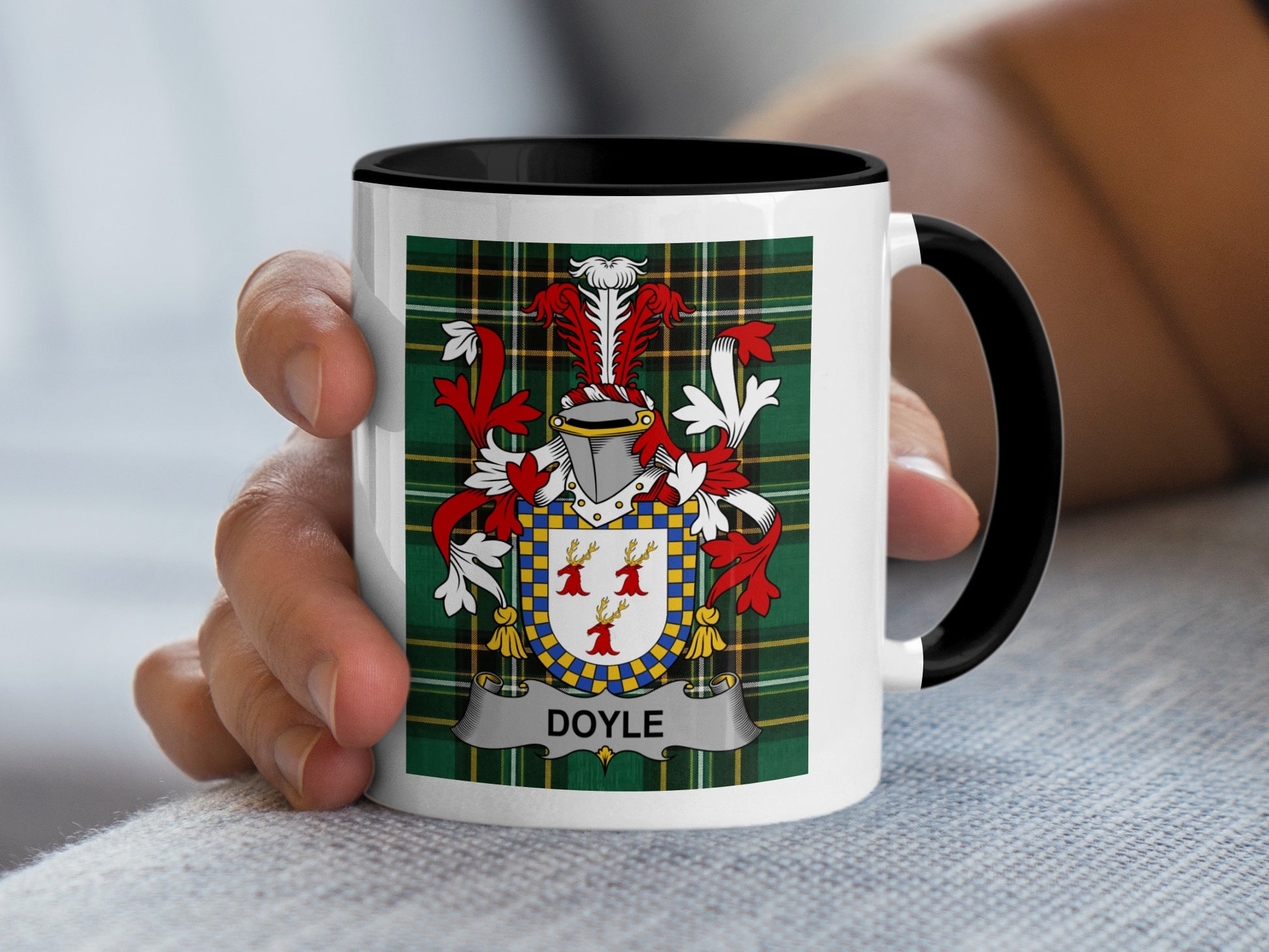 White mug with black rim featuring the Doyle family crest on tartan background.