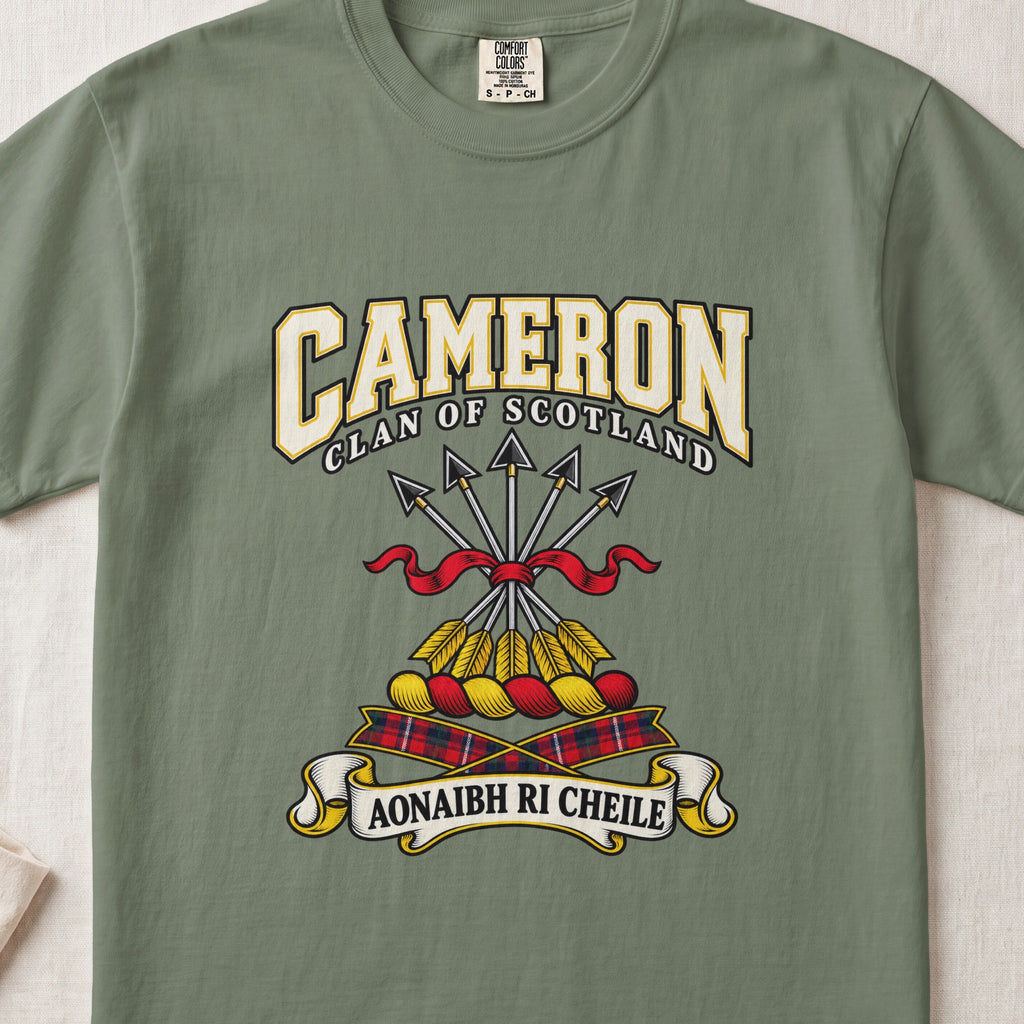 Cameron graphic T-shirt in Moss green, front flat lay showing varsity lettering and five arrows tied with red ribbon.