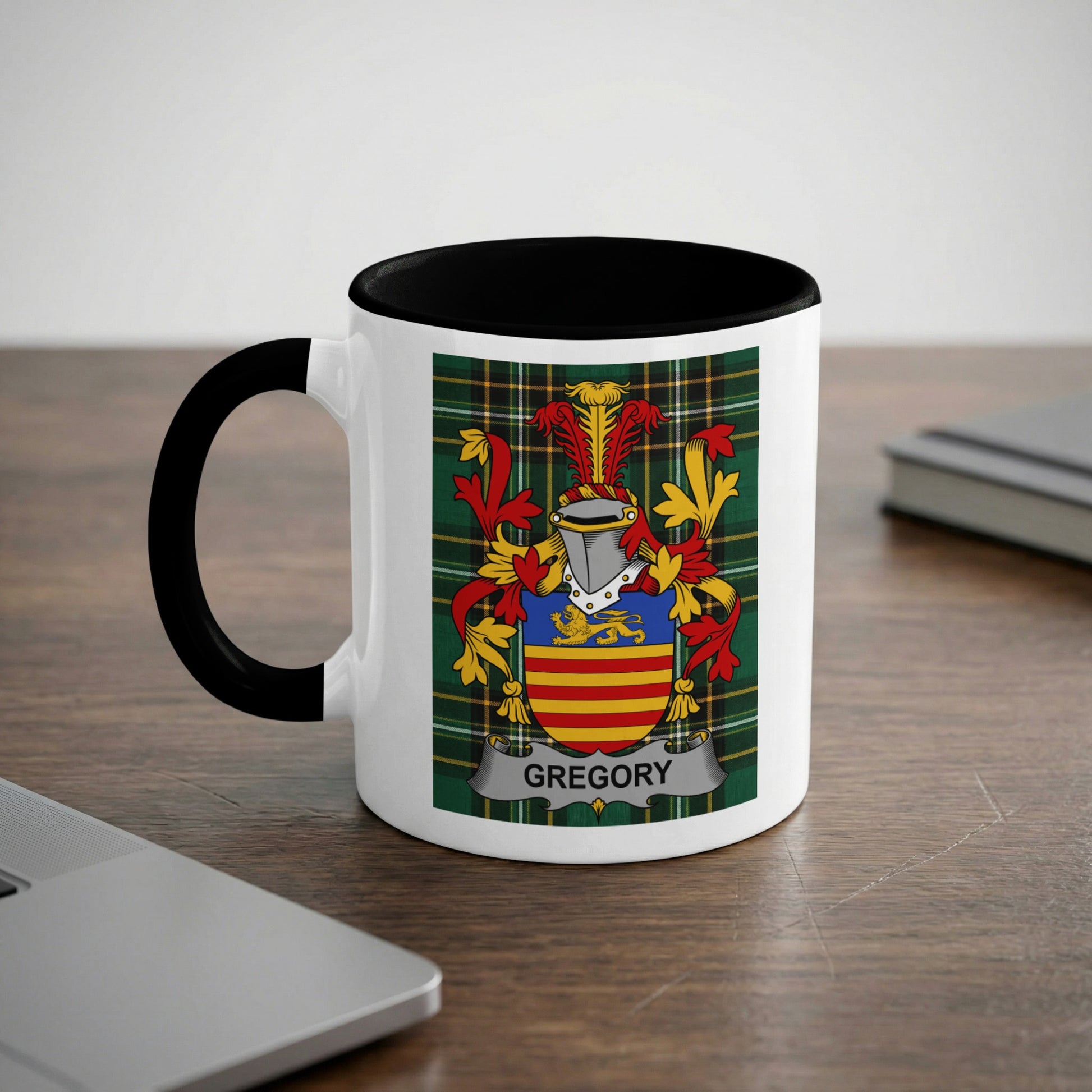 White mug with black rim and handle, featuring the Gregory family crest.