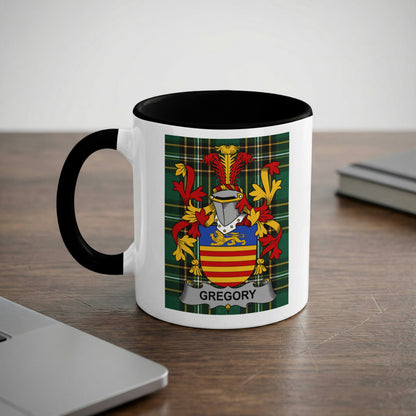 White mug with black rim and handle, featuring the Gregory family crest.
