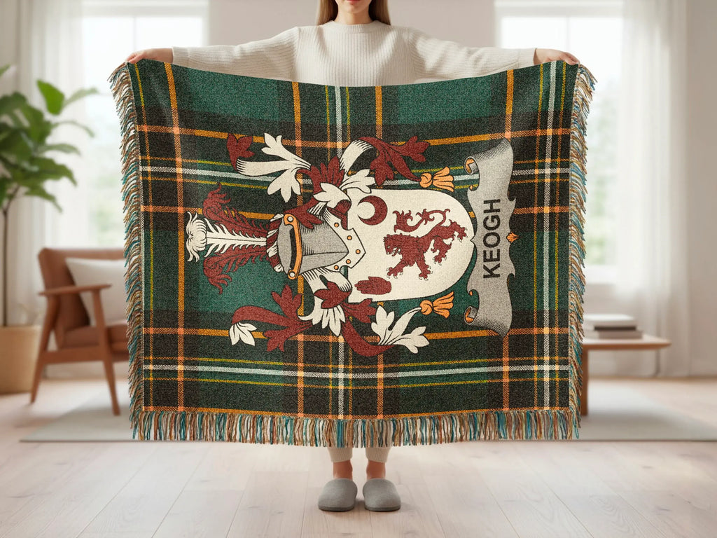Tartan blanket with Keogh family crest and fringed edges.