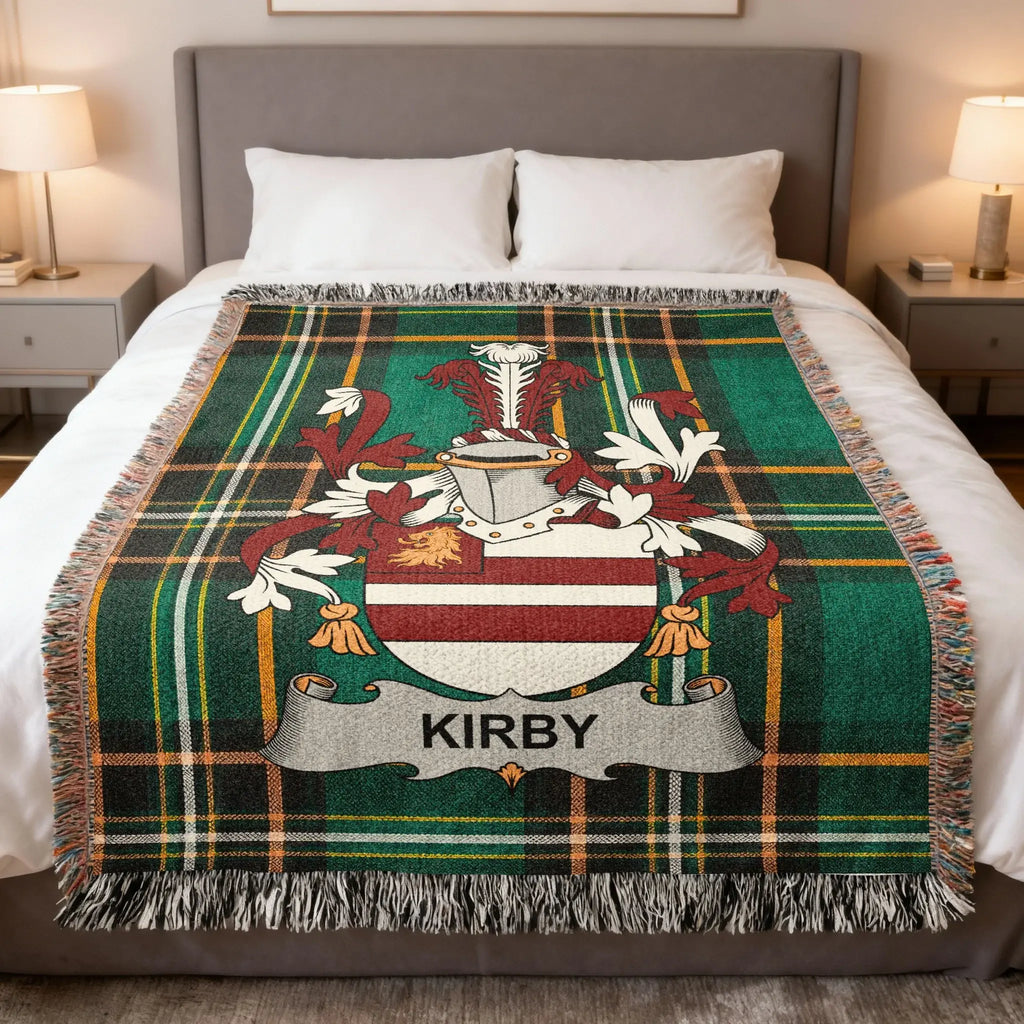 KIRBY family crest on a green tartan plaid woven blanket on a bed.