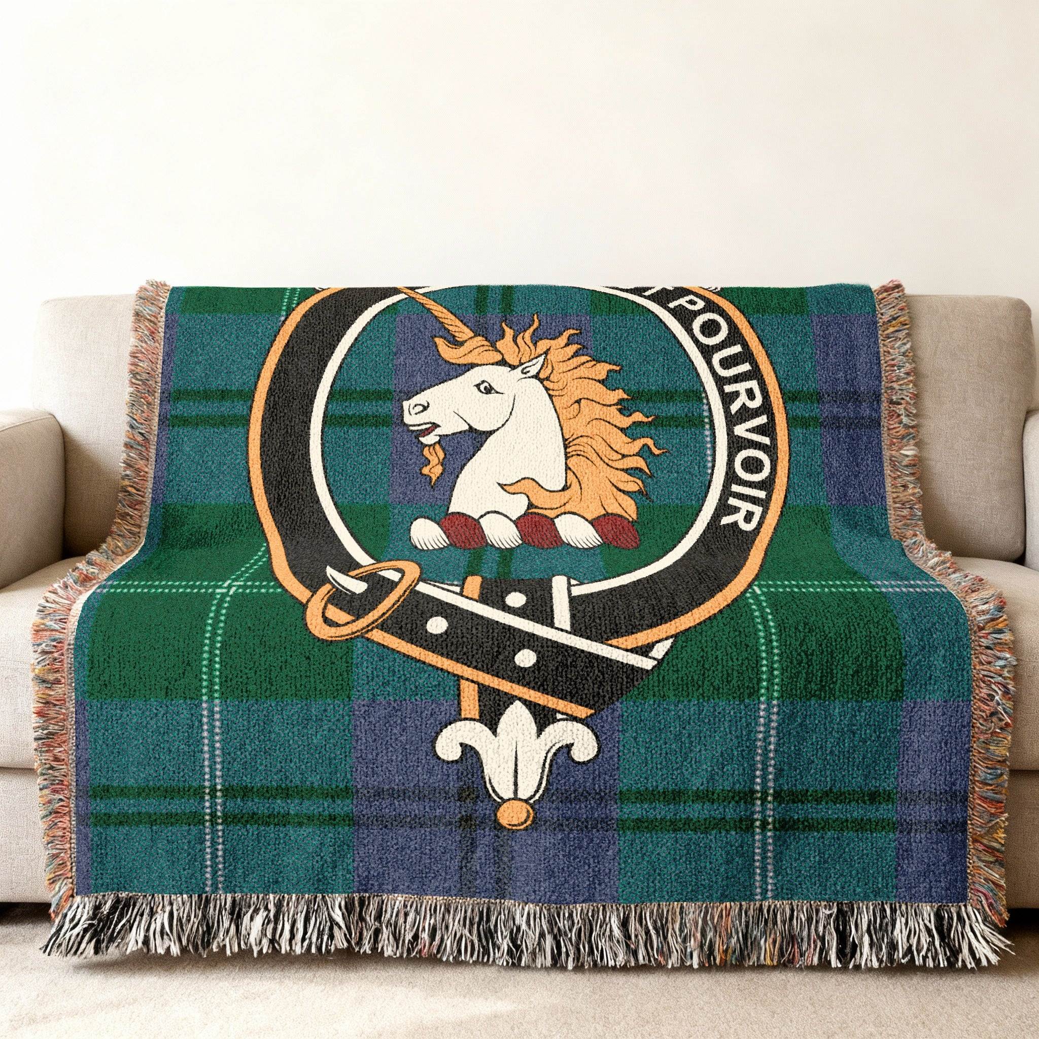 Oliphant tartan woven blanket folded — showing crest and green plaid design