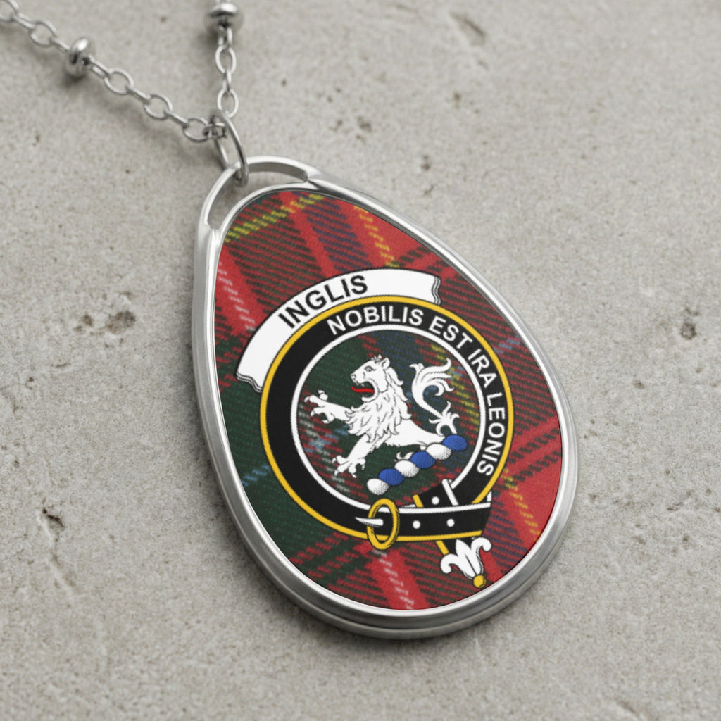 Inglis clan Scottish tartan necklace with clan crest and Nobilis Est Ira Leonis motto on tartan background