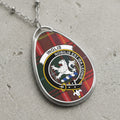 Inglis clan Scottish tartan necklace with clan crest and Nobilis Est Ira Leonis motto on tartan background