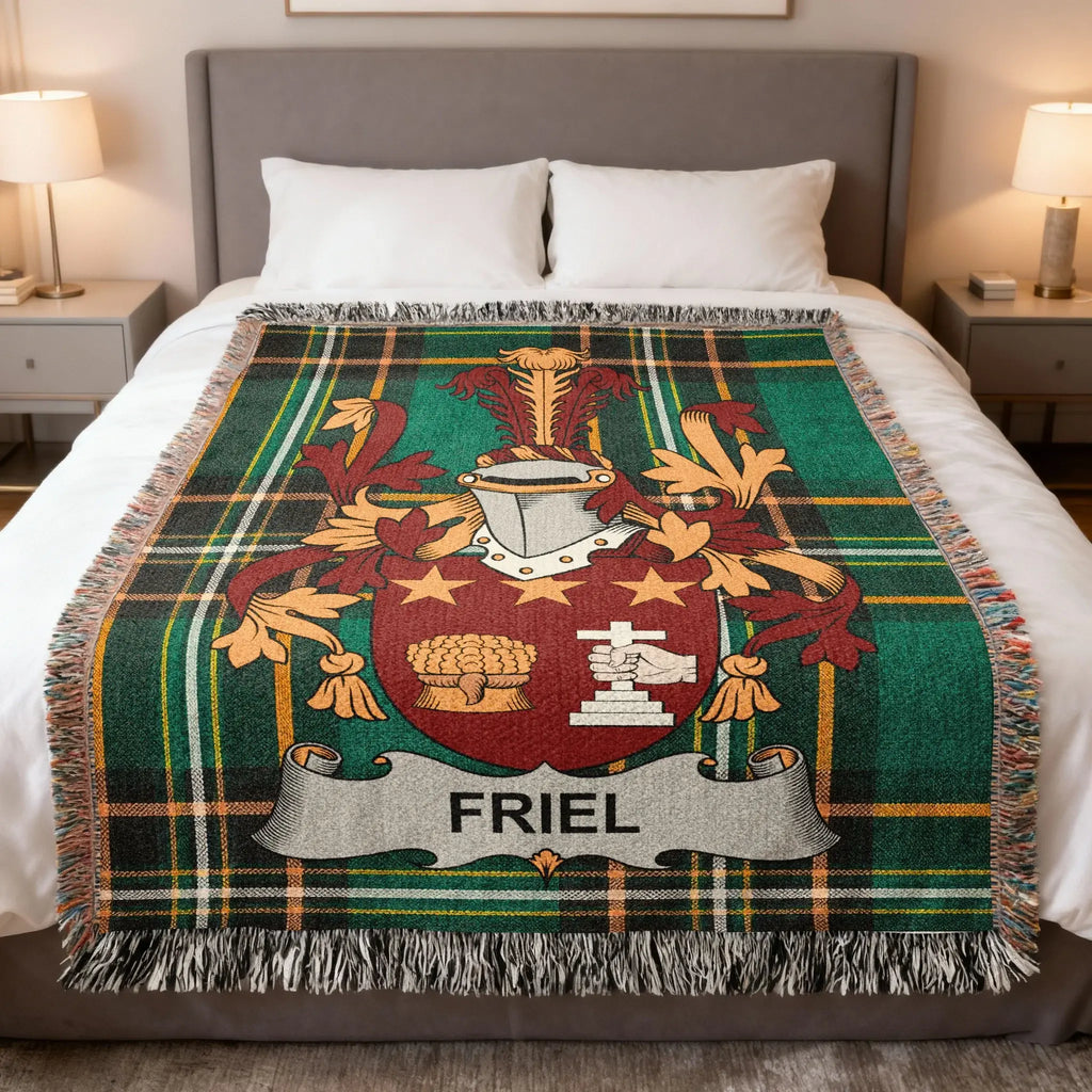 Tartan blanket featuring the Friel family crest draped on a bed.
