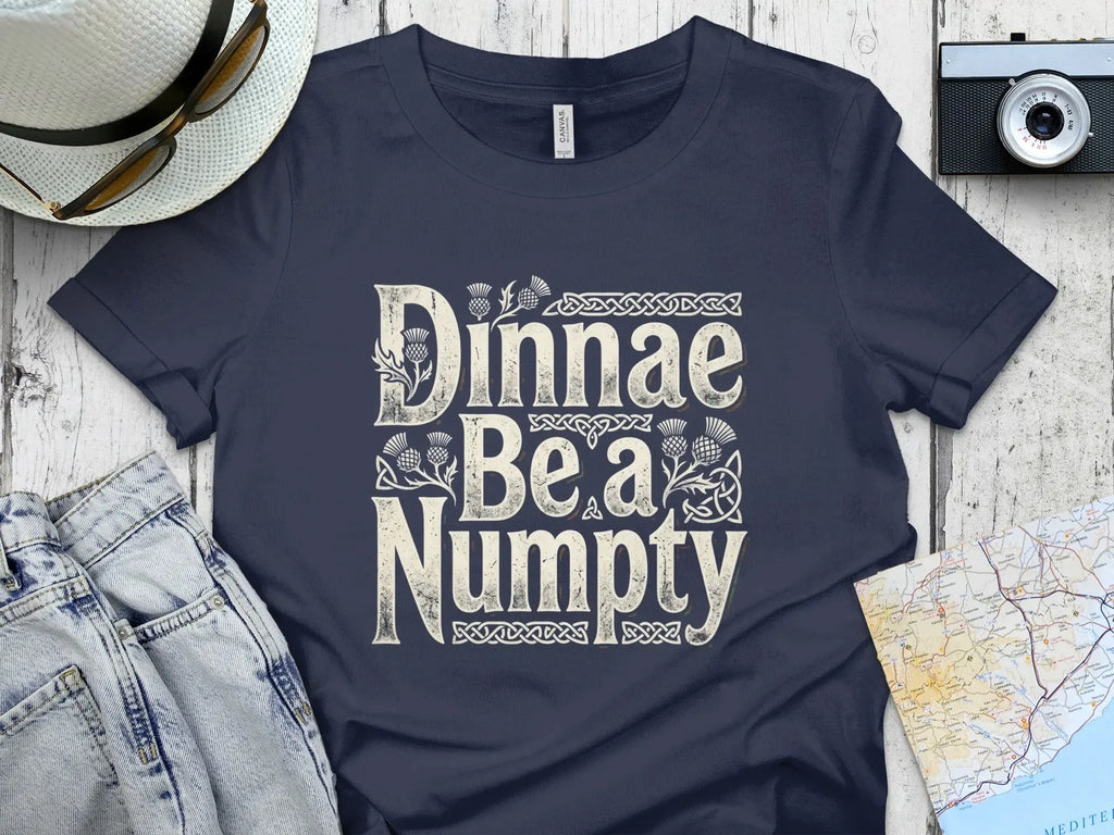 Navy t-shirt with "Dinnae Be a Numpty" in a Celtic knot design.