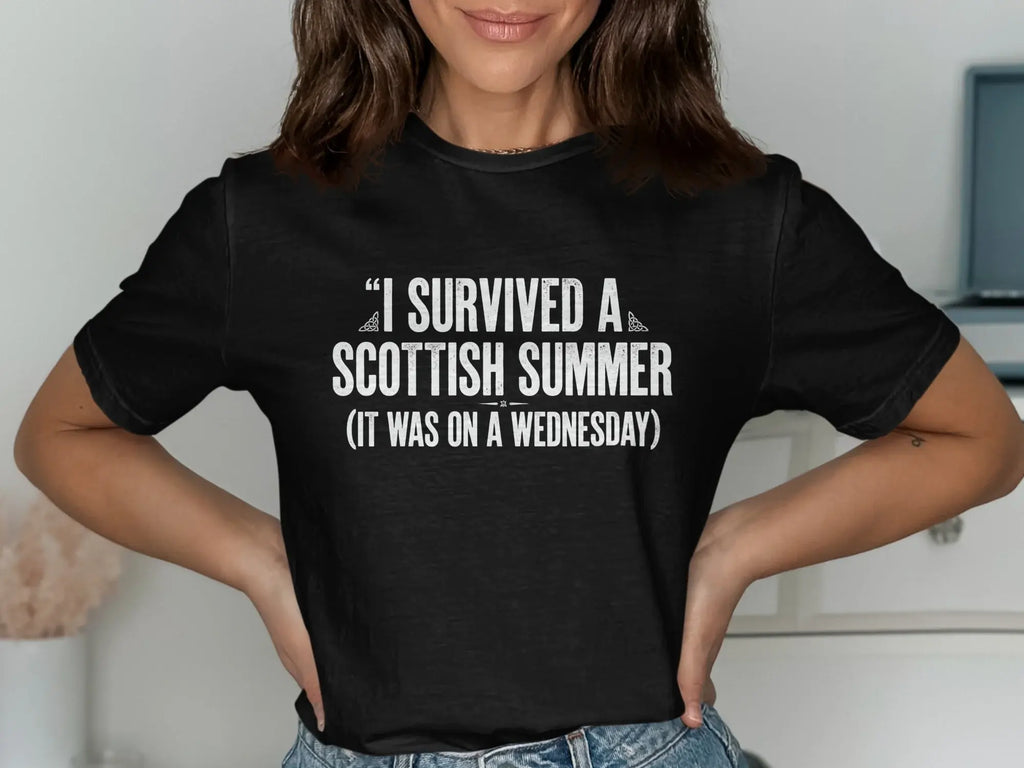 Black t-shirt with "I survived a Scottish summer (it was on a Wednesday)" text.