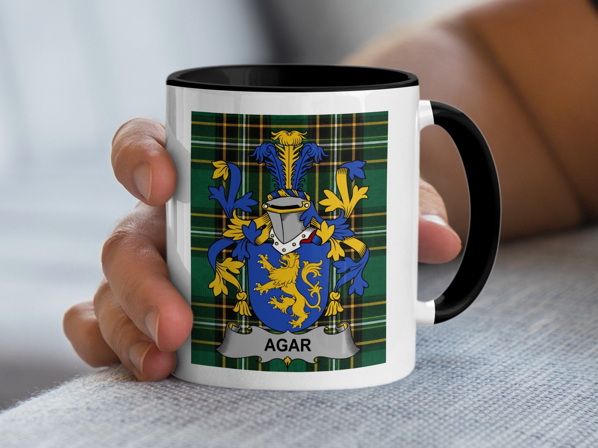 White mug with black rim featuring a coat of arms and "AGAR" text.