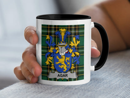 White mug with black rim featuring a coat of arms and "AGAR" text.