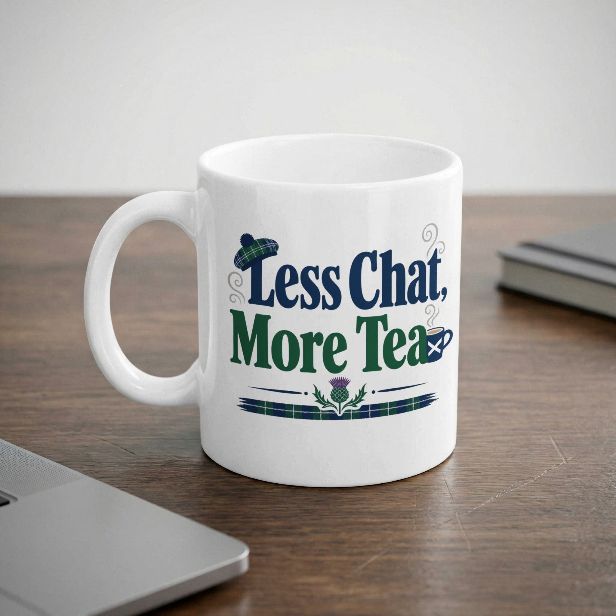 White mug with "Less Chat, More Tea" text and Scottish thistle design.