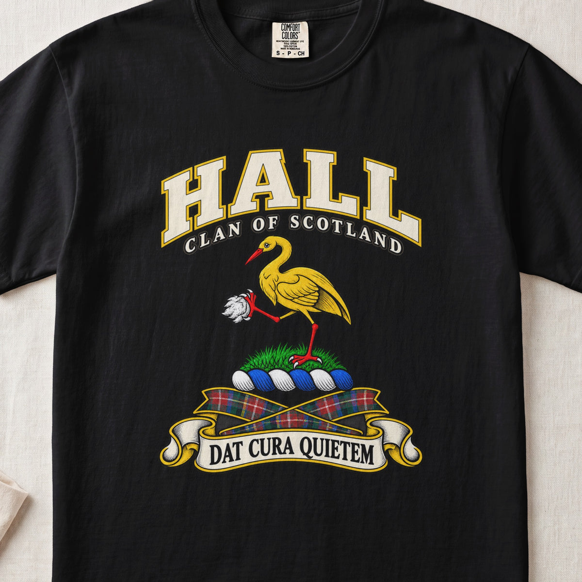 Hall Scottish clan T-shirt in Black, front view with a golden crane holding a white stone and motto banner.