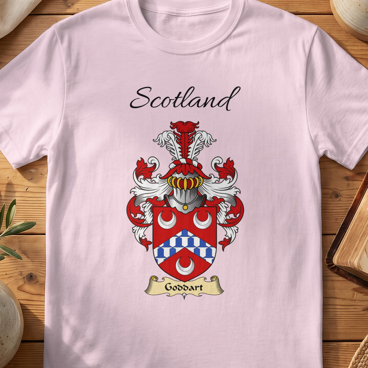 Light Pink Goddart Scottish family shield T-shirt featuring a blue-and-white chevron between white crescents
