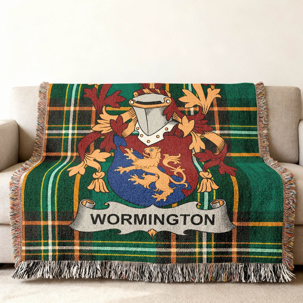 Wormington family crest on a green tartan blanket with fringe.