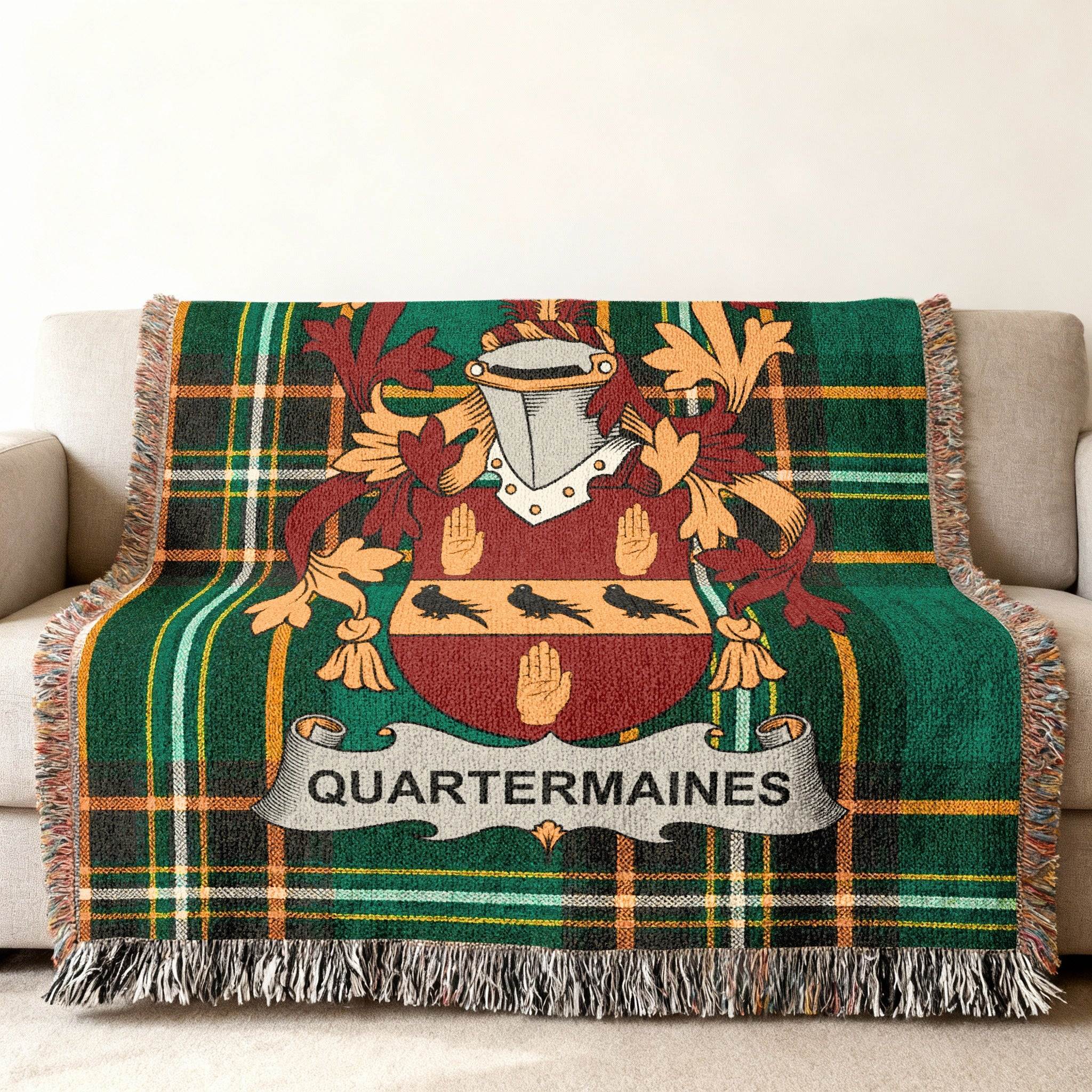 Green tartan throw blanket with Quartermaines coat of arms.