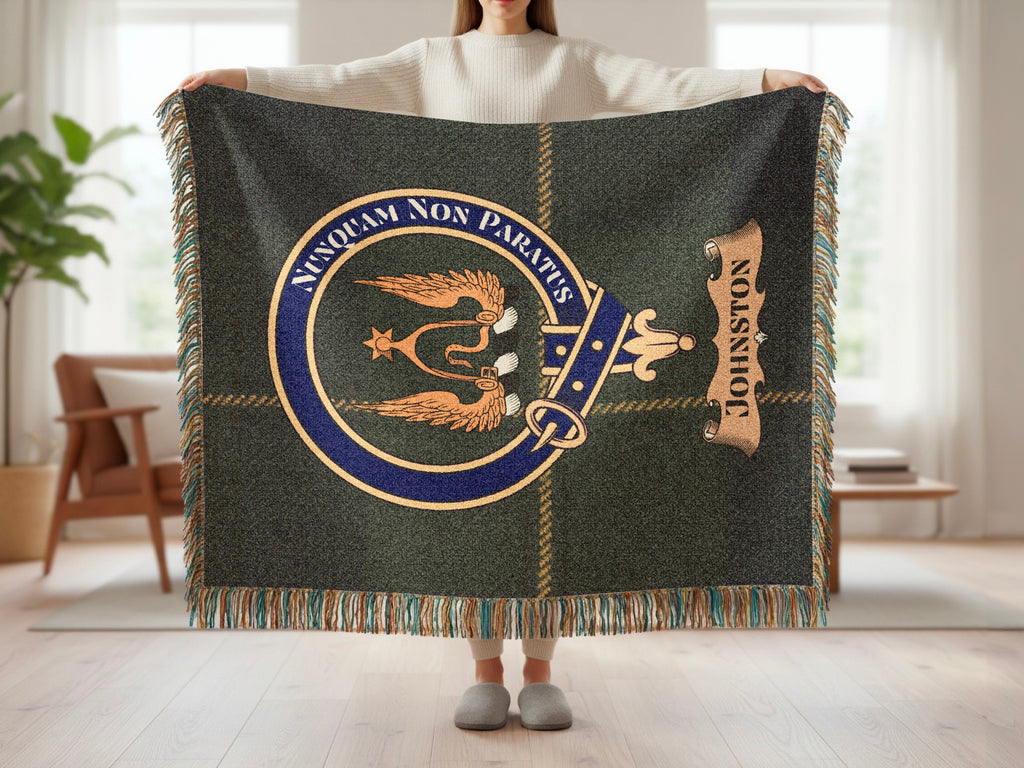 Johnston clan crest with Nunquam Non Paratus motto on green tartan woven blanket