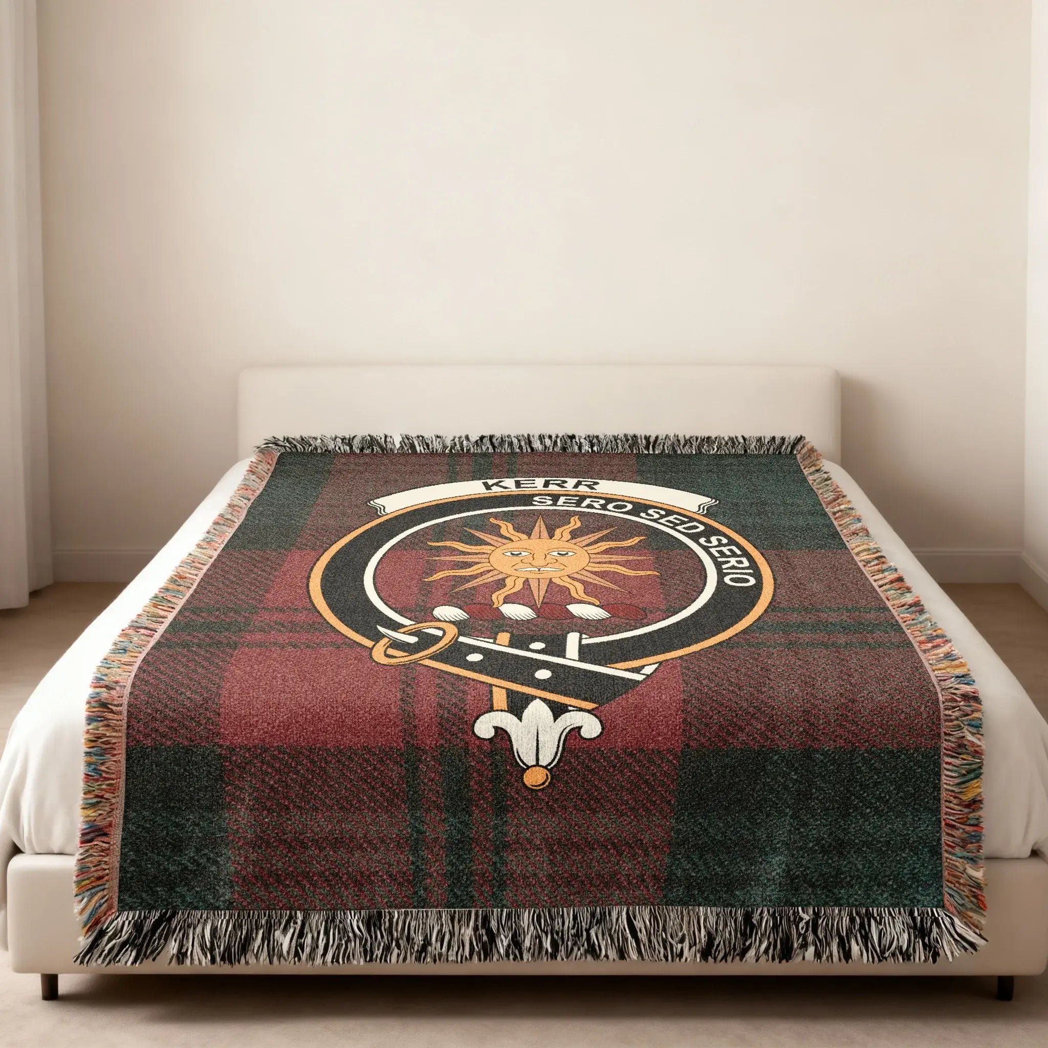Kerr Sero Sed Serio clan crest tartan woven blanket — heraldic design at centre, fringe edge visible