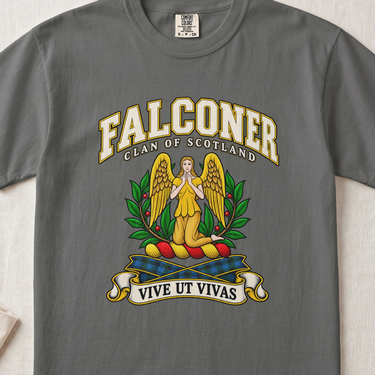 Falconer Scottish clan T-shirt in Pepper, front view with a kneeling gold-winged figure surrounded by green branches and motto banner.