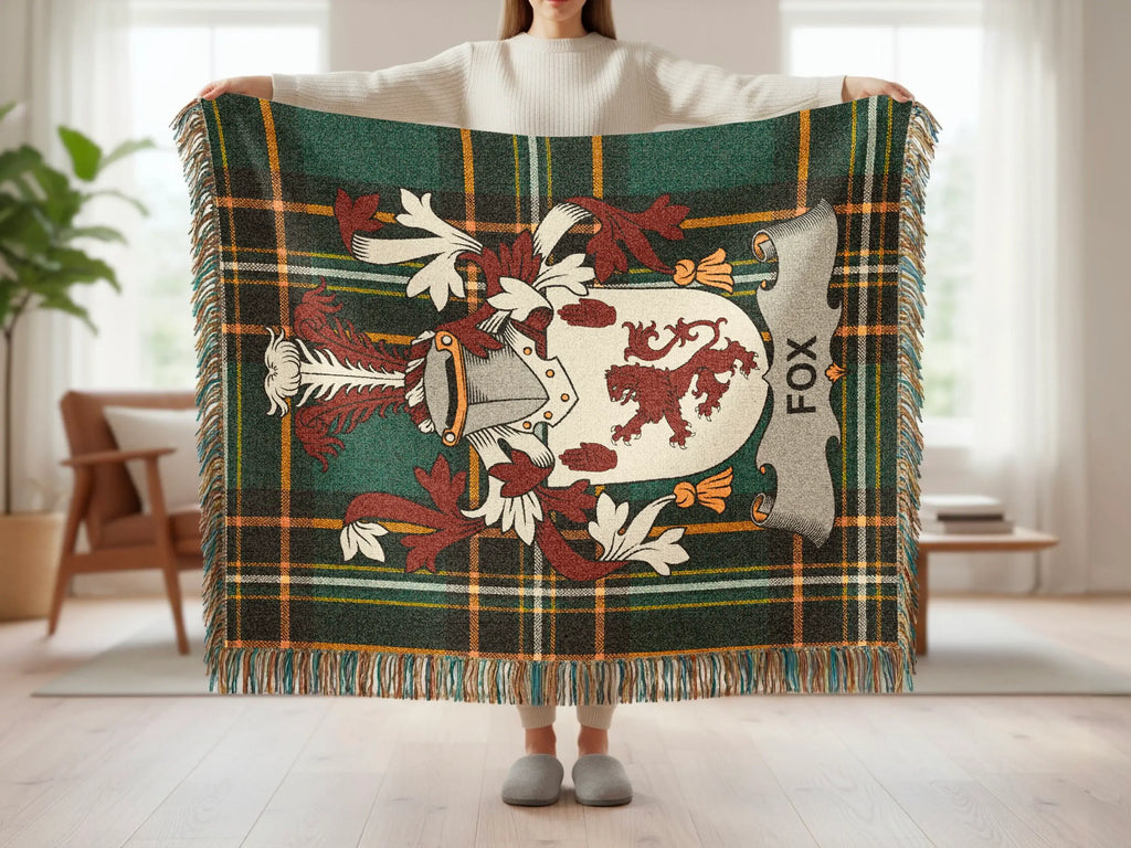 Tartan blanket with Fox crest and coat of arms, held by a person.