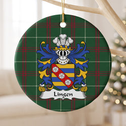 Lingen ceramic ornament hanging from a pale wooden branch, showing a blue-and-gold striped shield with three white roses on a red diagonal band on Welsh national tartan.